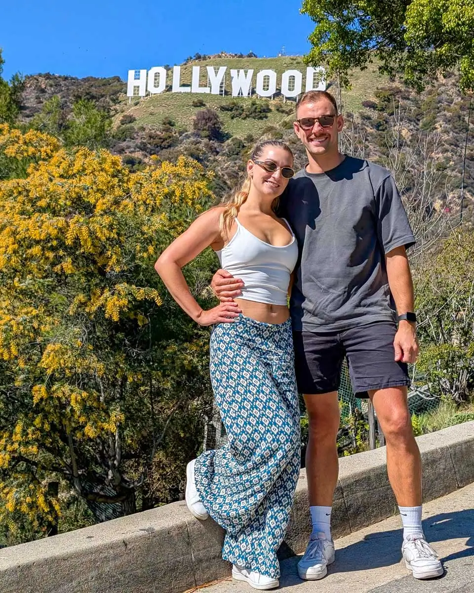 Bailey and Daniel stand by the Hollywood sign in Los Angeles, California, United States