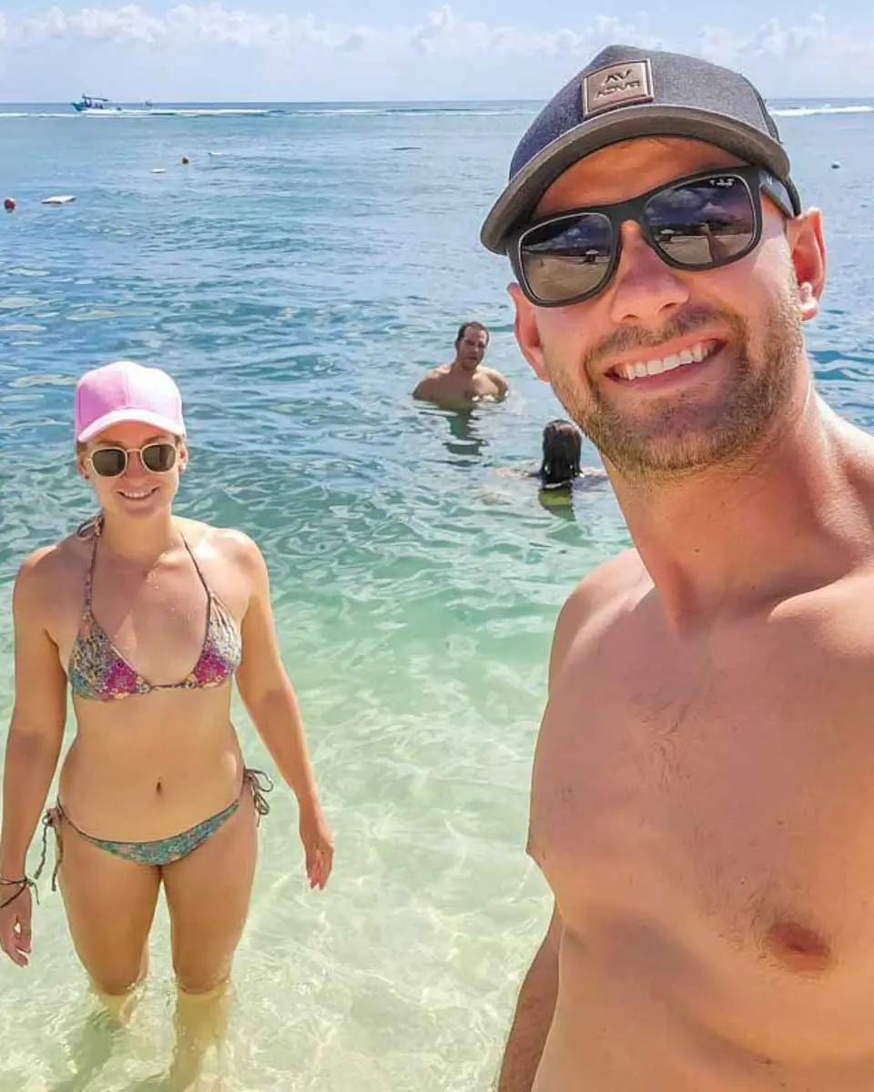 Bailey and Daniel taking a selfie at a beach in Nassau
