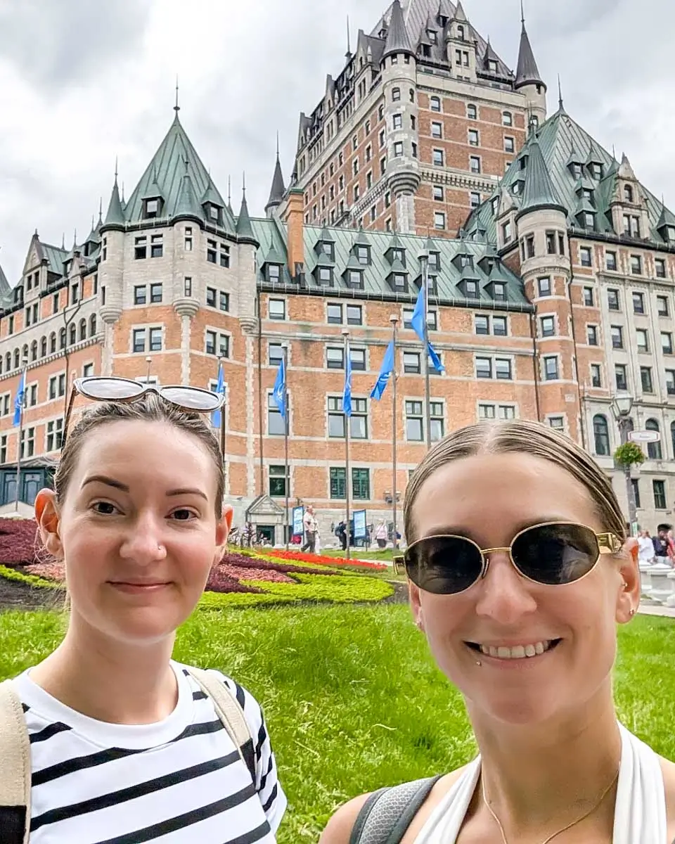 Bailey and her friend taking a selfie in front of Fairmont Le Château Frontenac in Quebec City