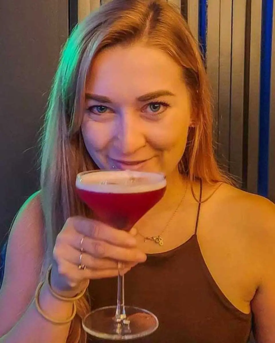 Bailey drinking cocktail at a bar in Newport Beach