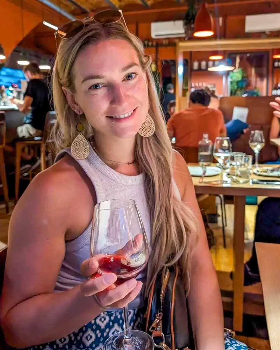 Bailey drinking wine at Evoè in Syracuse, Italy