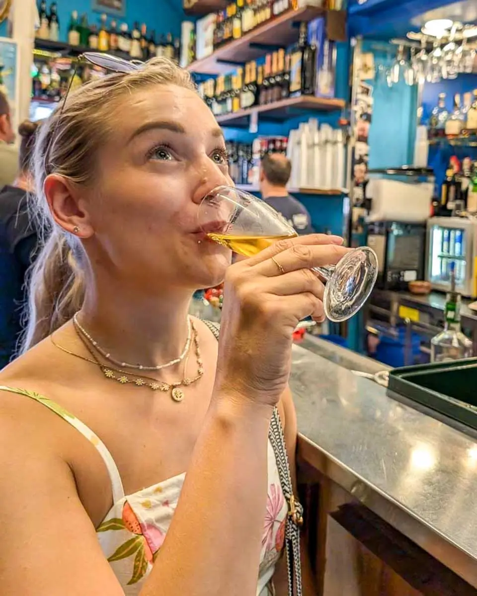 Bailey drinking wine on a food tour in the Quebec City