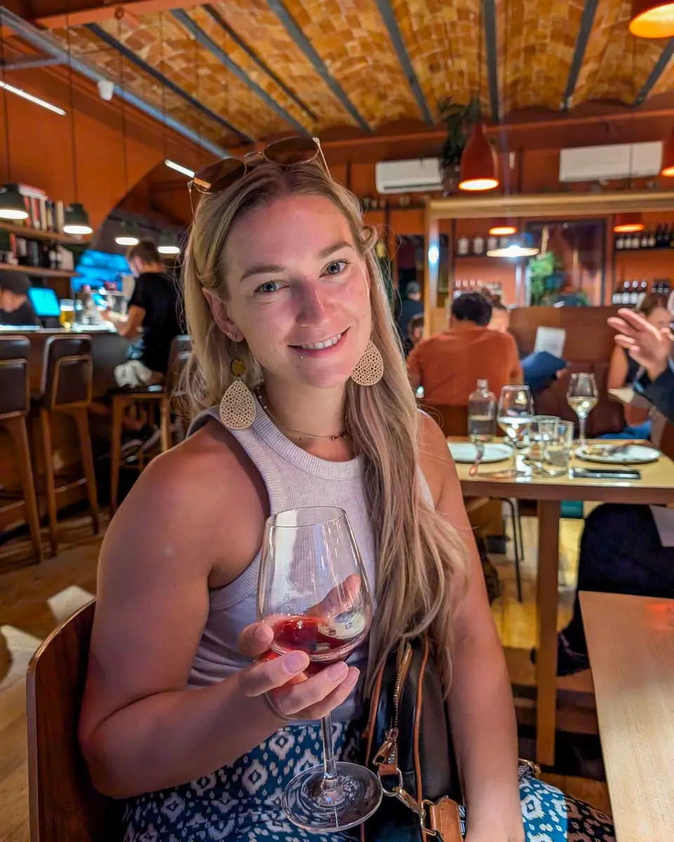 Bailey drinking wine on a tapas and wine tour in Barcelona, Spain