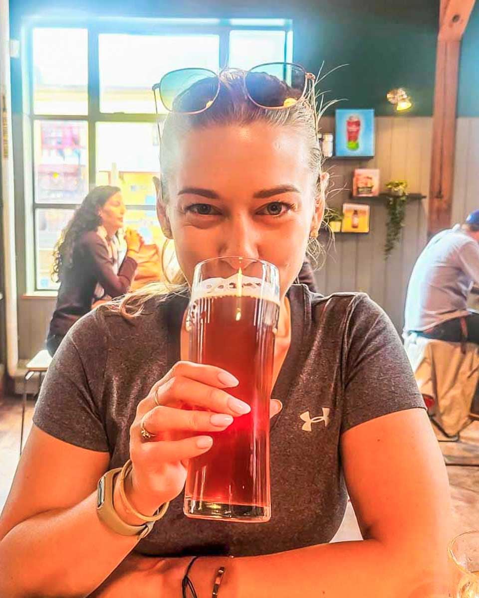 Bailey drinks a beer at a brewery in Boulder