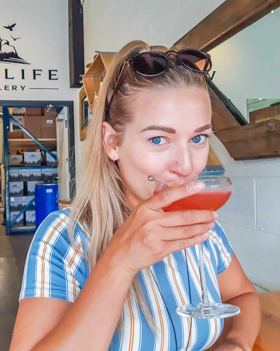 Bailey drinks a cocktail at Wildlife Distillery in Canmore