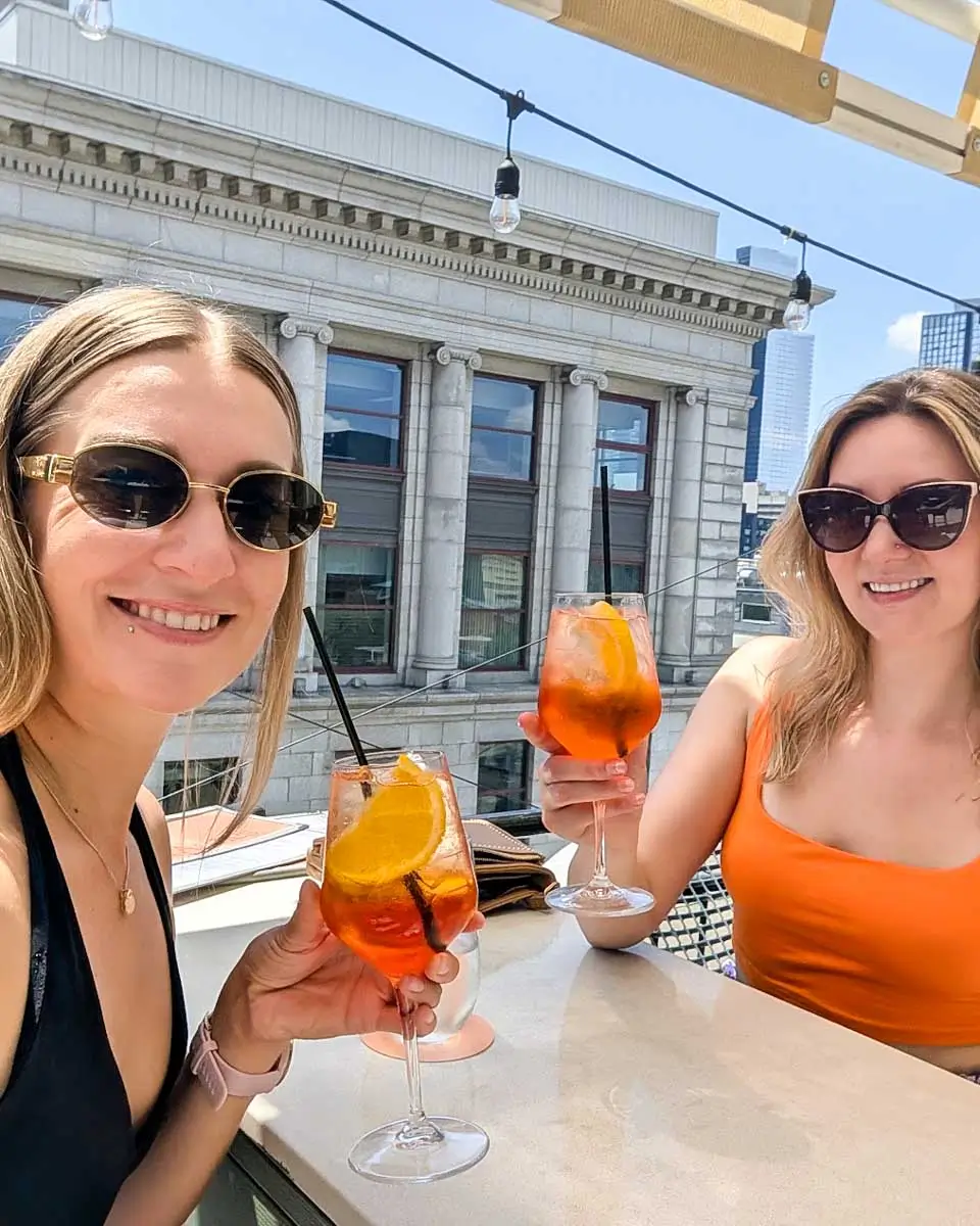 Bailey enjoying a drink with her friend at Terrasse Place D’Armes in Montreal, Quebec