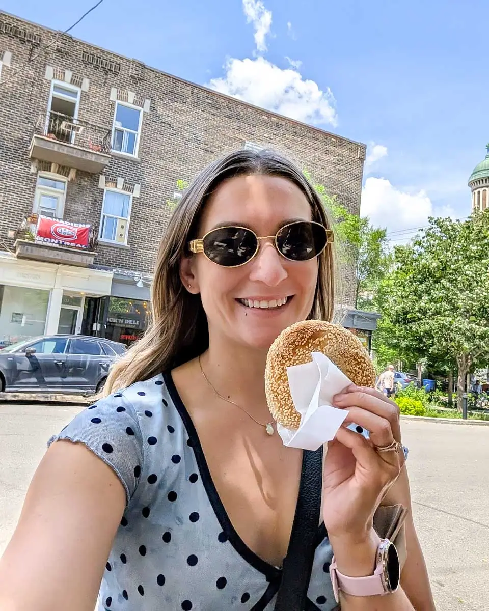 Bailey holding a bagel on a food tour in Montreal, Quebec 2