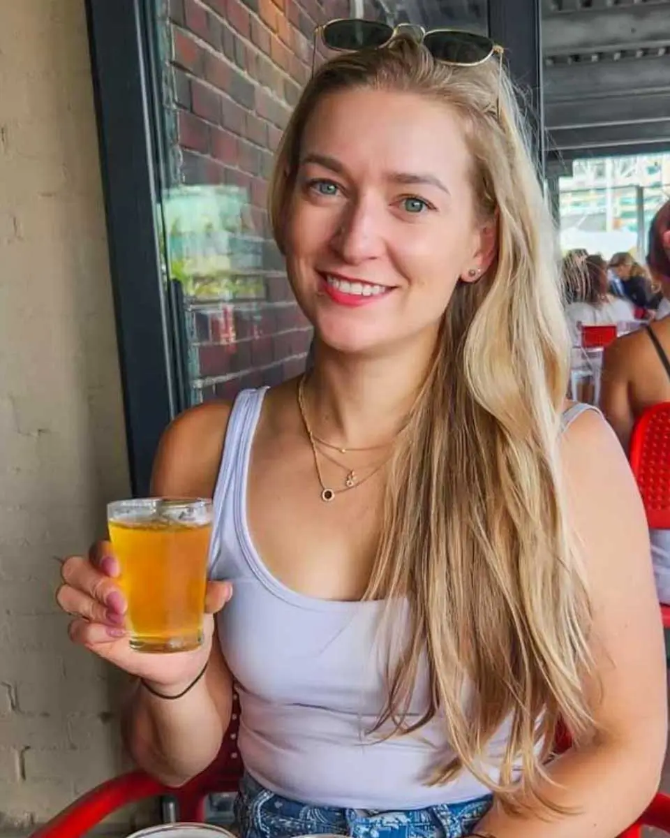 Bailey holding a glass of beer on a South Beach food and walking tour in Miami, Florida