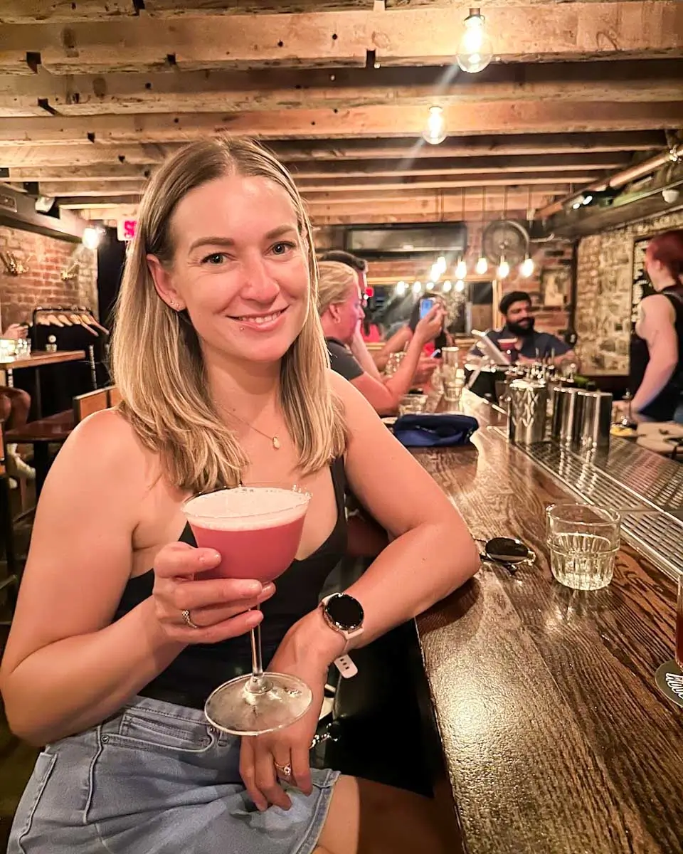 Bailey holding the drink at the Coldroom speakeasy in Montreal, Quebec