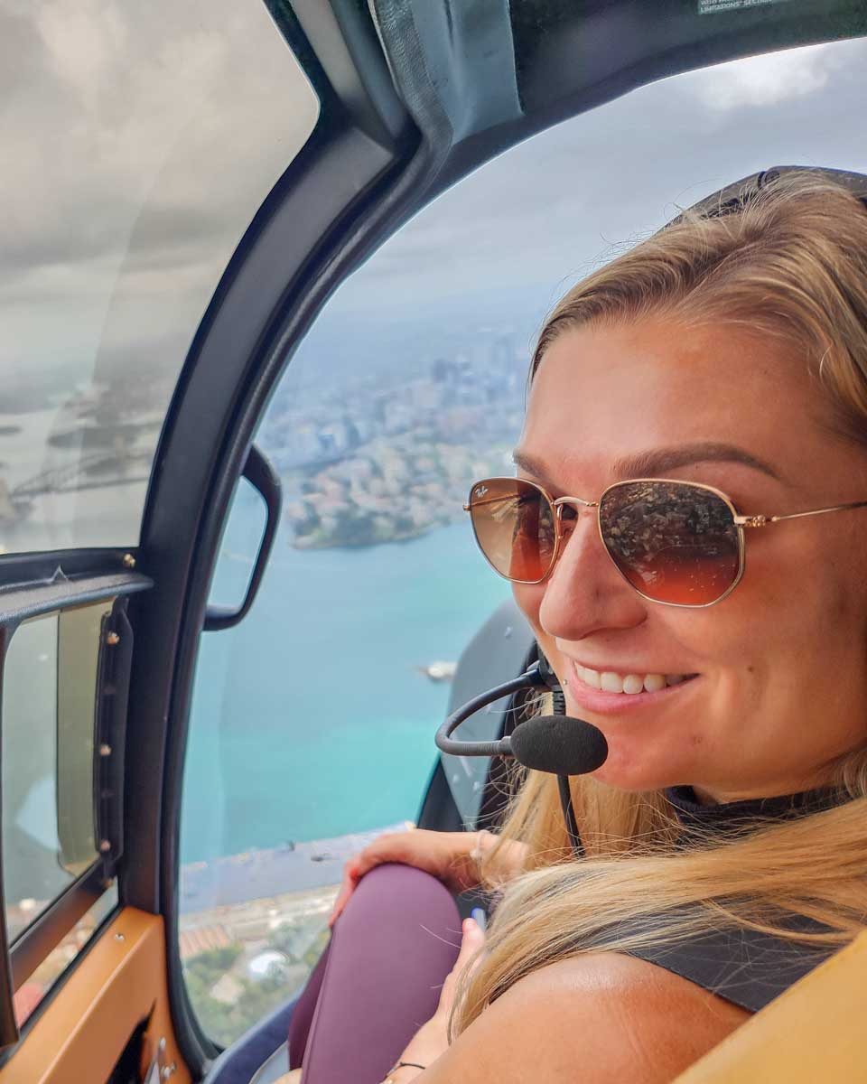 Bailey smiles at the camera while on flight above the Newport beach