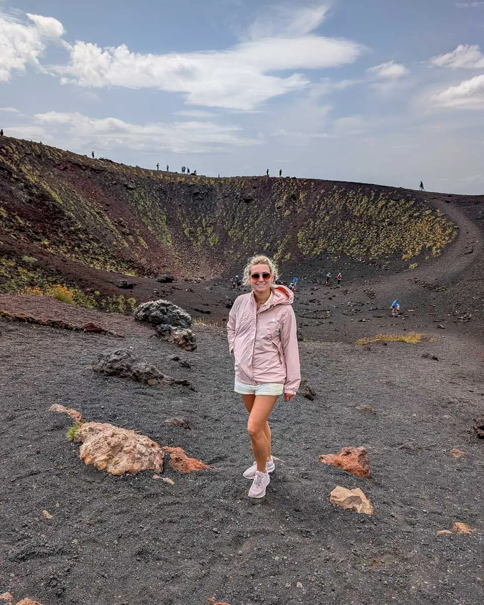 Bailey stands near a crater at Mt Etna visited on a tour from Syracuse, Italy