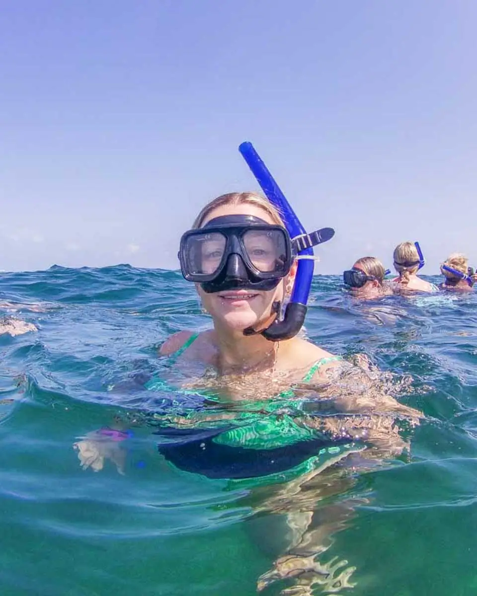 Bailey taking a selfie in the water with snorkel gear dring a tour in Cozumel, Mexico