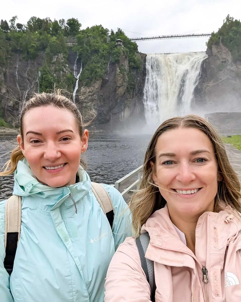 Bailey taking selfie with her friend in front of Montmorency Falls in Quebec