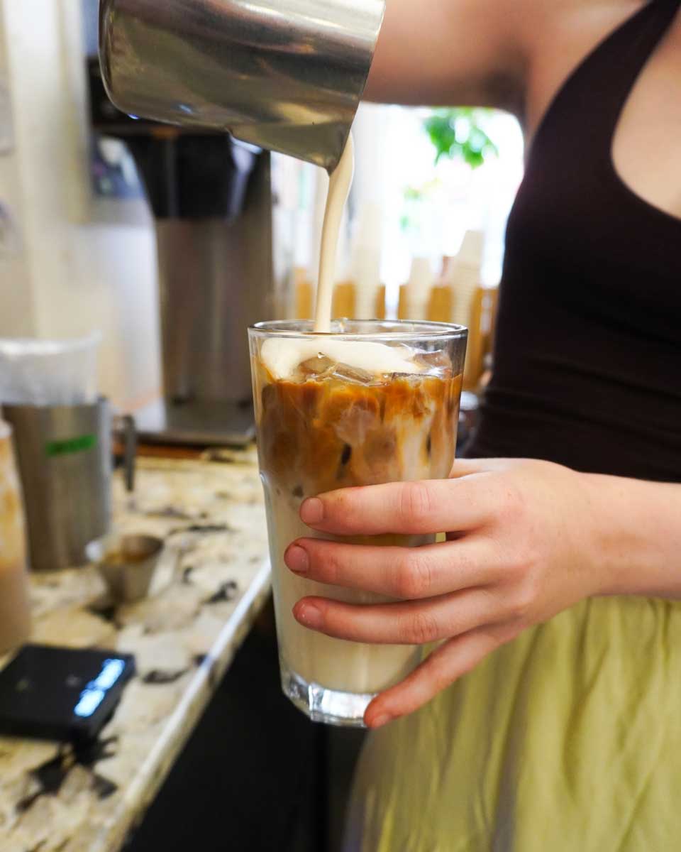 Barista makes an ice coffee at Ottawa Bike Cafe
