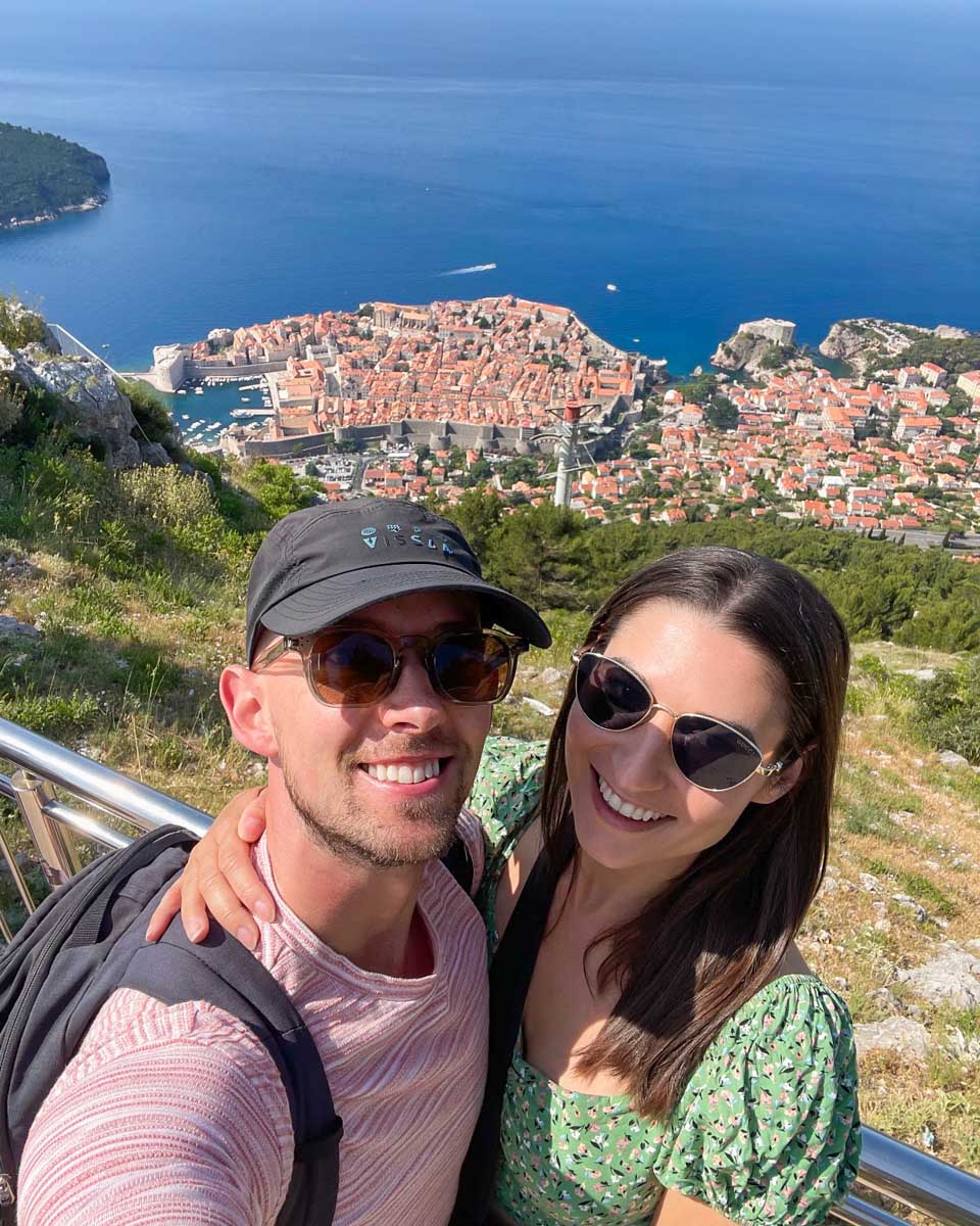 Brittni and Jesse take a selfie from thwe top of Mt Srd with Old Town Dubrovnik in the background