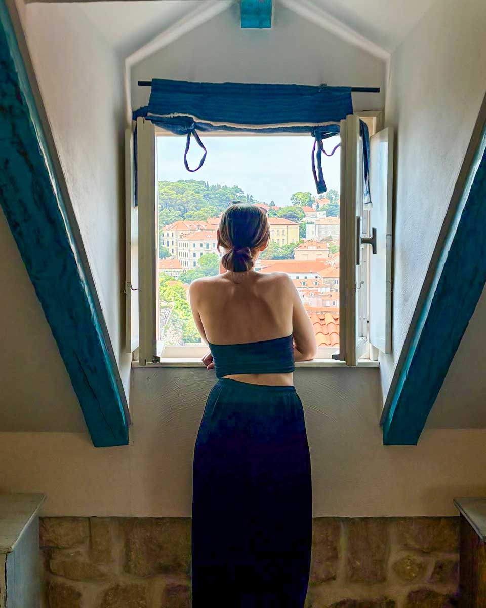 Brittni looks out the window at the view over Old Town from the hotel room at Rustico Guesthouse in Dubrovnik