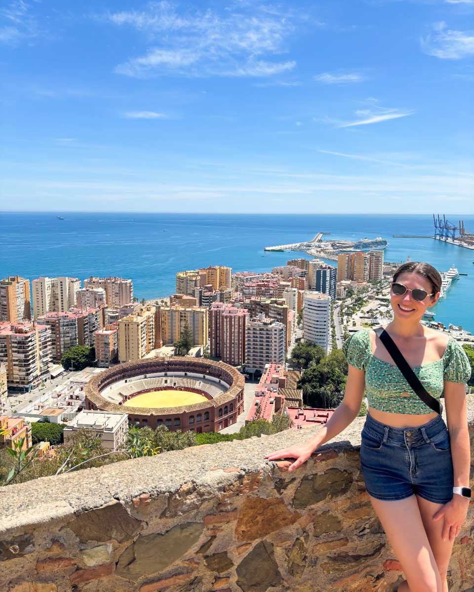 Brittni poses for a photo at Castillo de Gibralfaro with Malaga city in the background