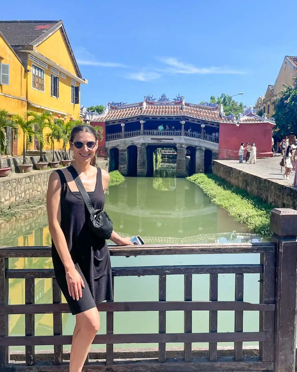 Brittni posing in front of the Japanese bridge in Hoi An, Vietnam