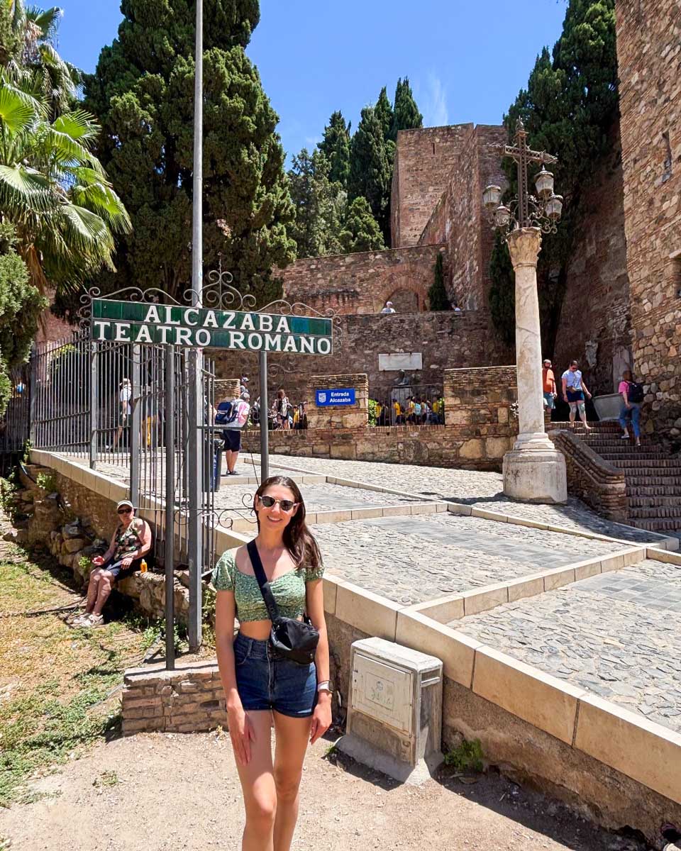 Brittni stands at the entrance to the Alcazaba and Roman Theatre in Malaga