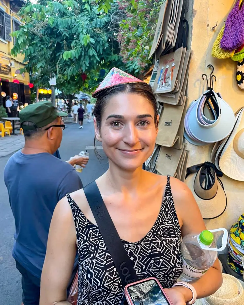 Brittni wearing traditional Vietnamese hat in Vietnam