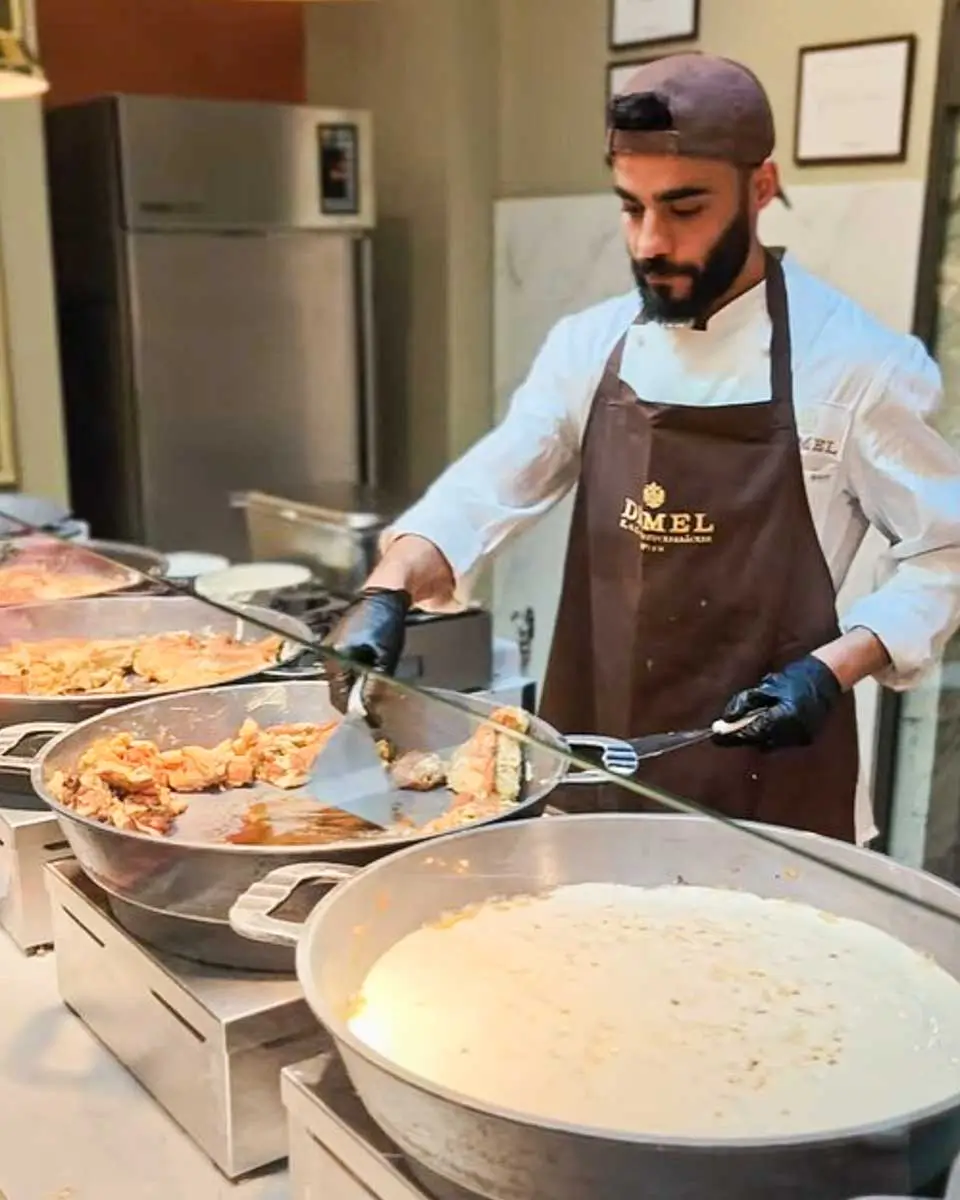 Chef preparing traditional Kaiserschmarrn at Demel Café in Vienna