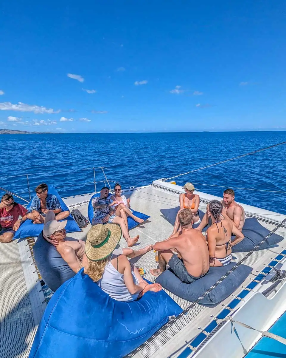 Daniel and Bailey relaxing with friends on a catamaran cruise in Cozumel, Mexico