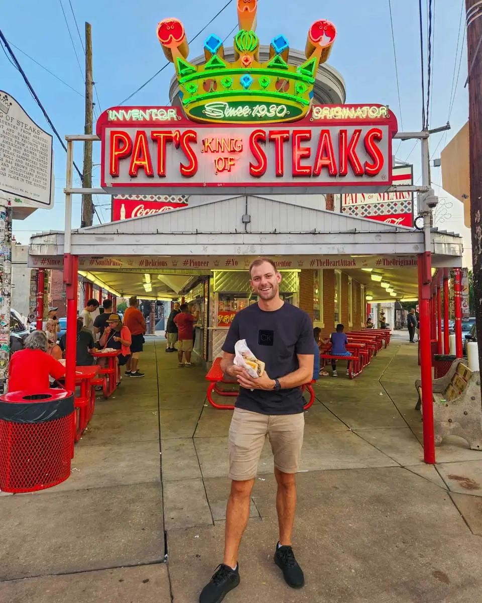 Daniel eats a cheesesteak at Pats in Philadelphia, USA