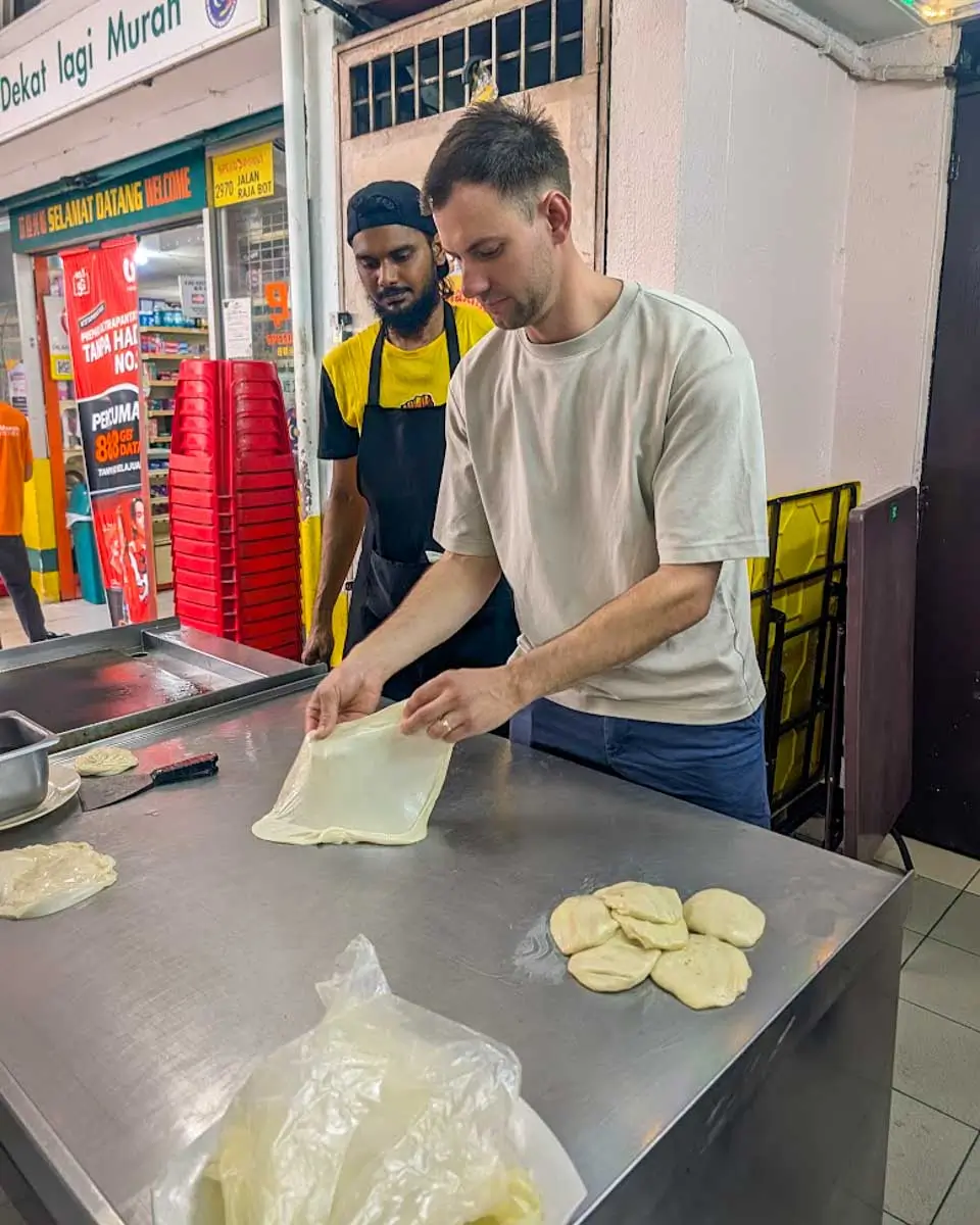 Daniel making roti on a food tour in Kuala Lumpur, Malaysia