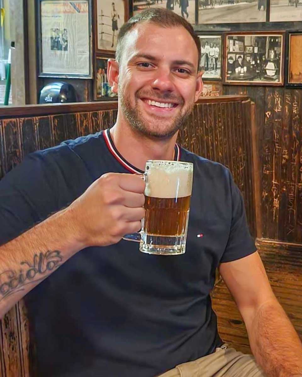 Daniel-poses-for-a-photo-at-a-pub-in-Canmore