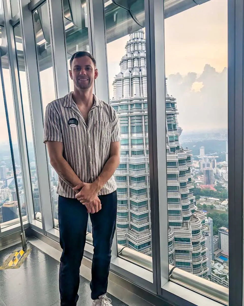 Daniel taking a photo at the top of Petronas Tower in Kuala Lumpur, Malaysia