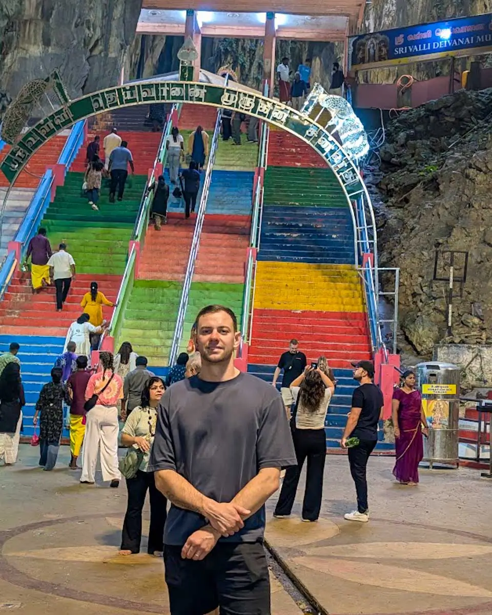 Daniel taking a photo inside the Batu Caves in Kuala Lumpur, Malaysia