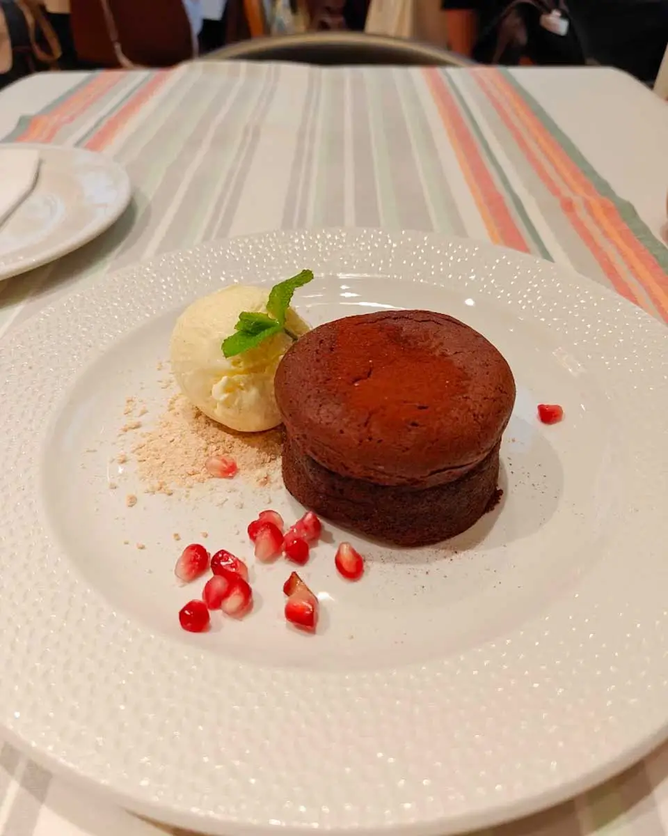 Dessert served with icecream and pomegranate seeds at Menza Restaurant in Budapest

