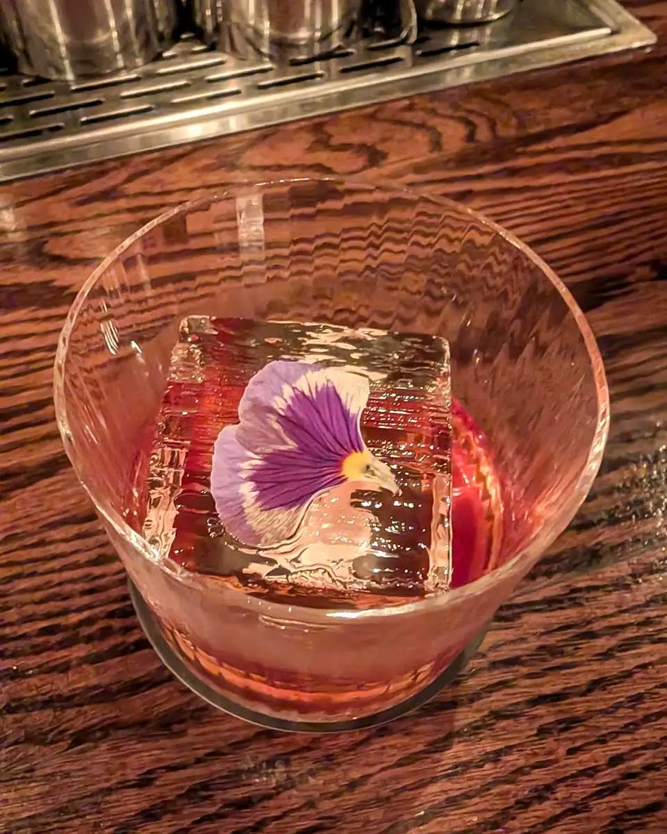 Drink served with a flowery icecube at the Coldroom speakeasy in Montreal, Quebec