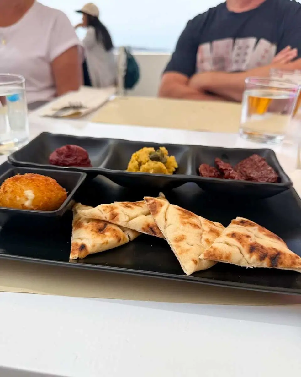 Eating delicious local dishes on a food tour in Santorini
