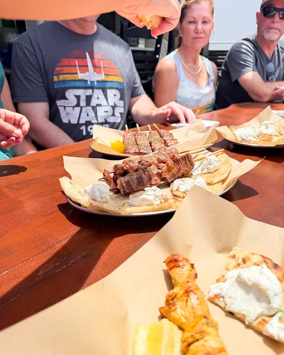 Eating souvlaki on a food tour in Santorini, Greece