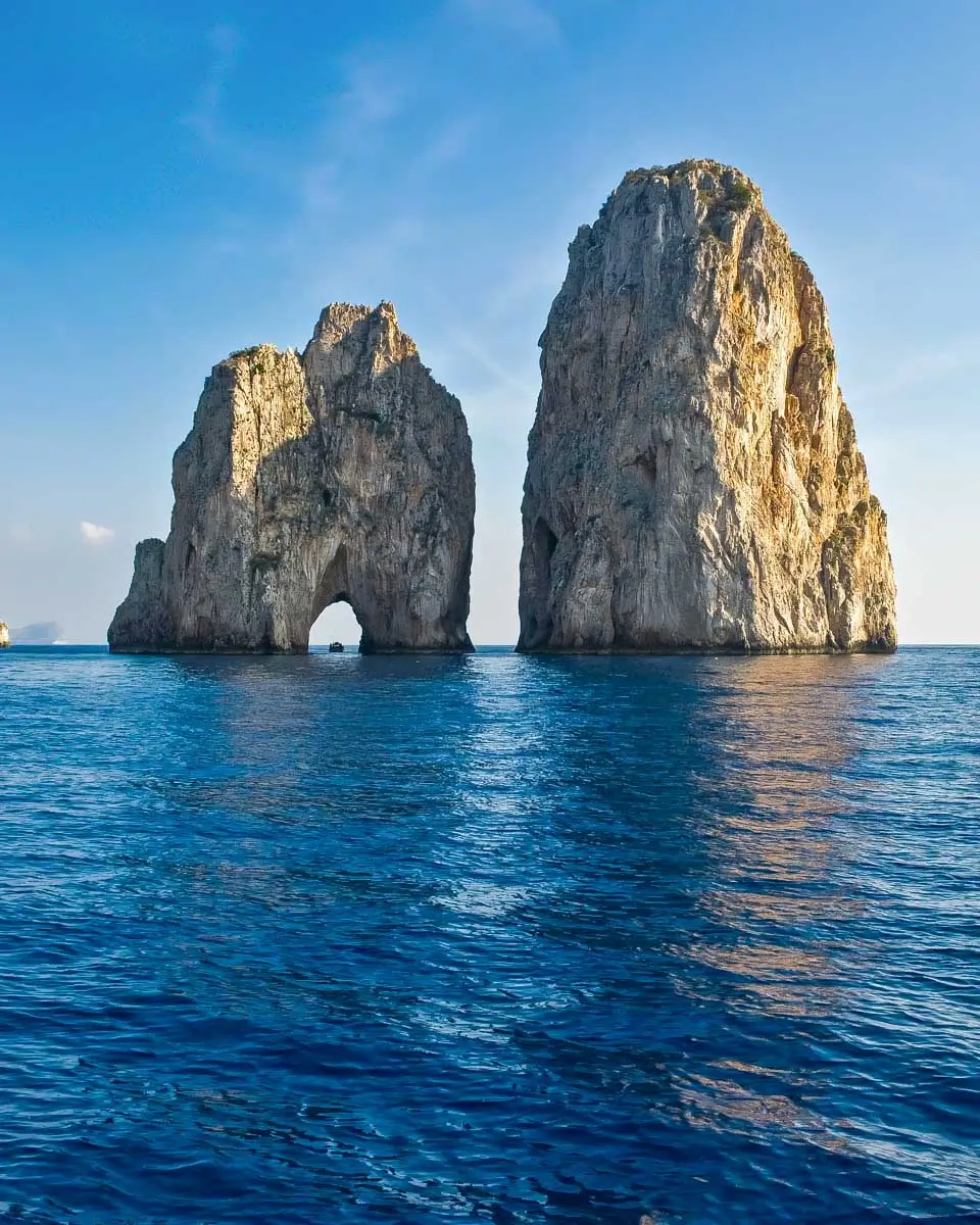Faraglioni rock formation seen off of the coast of Capri on a tour from Sorrento, Italy