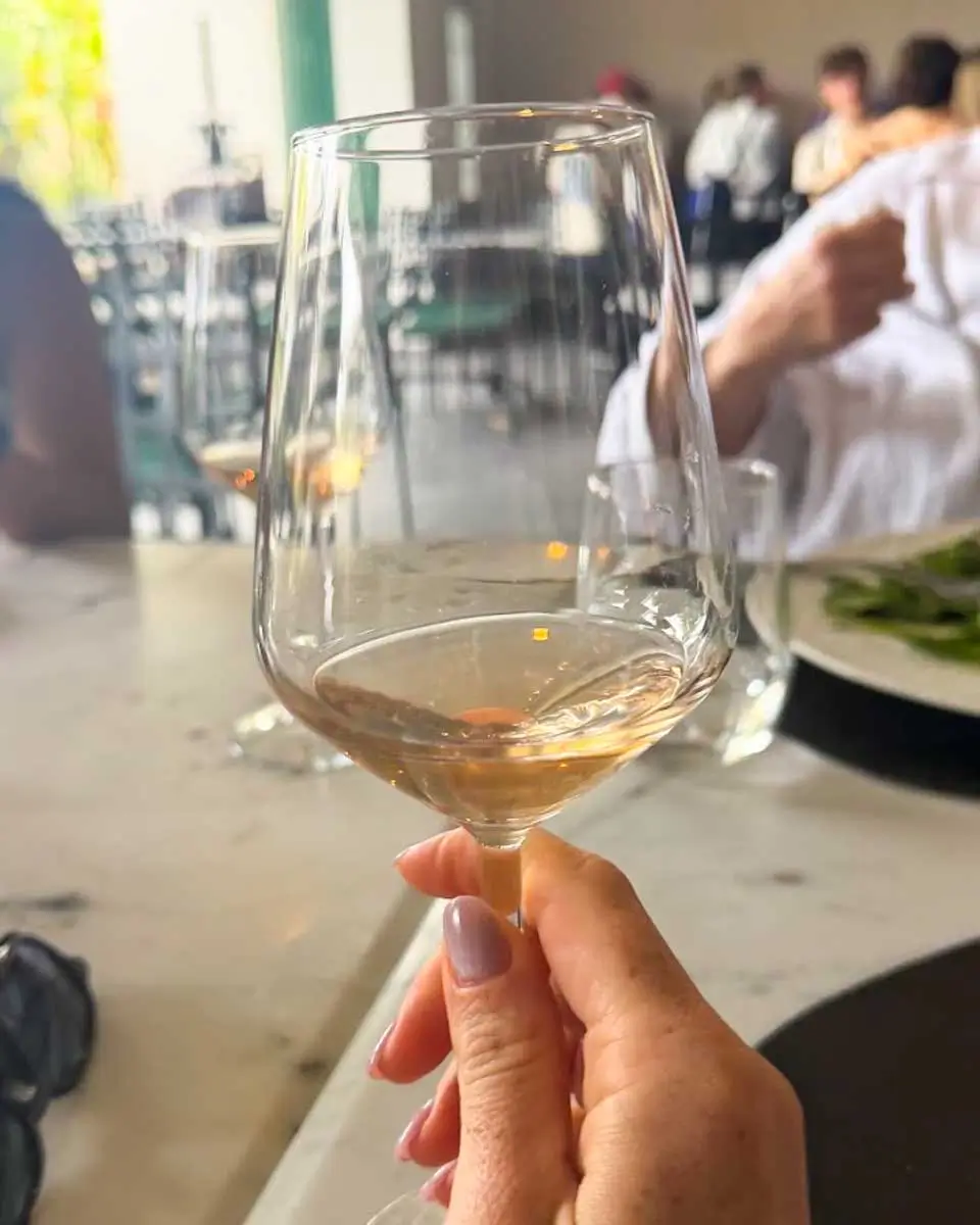 Hannah drinking wine on a food tour in Crete, Greece