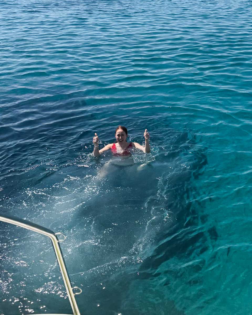 Hannah gives a thumbs up in the water on a Naxos boat tour in Greece