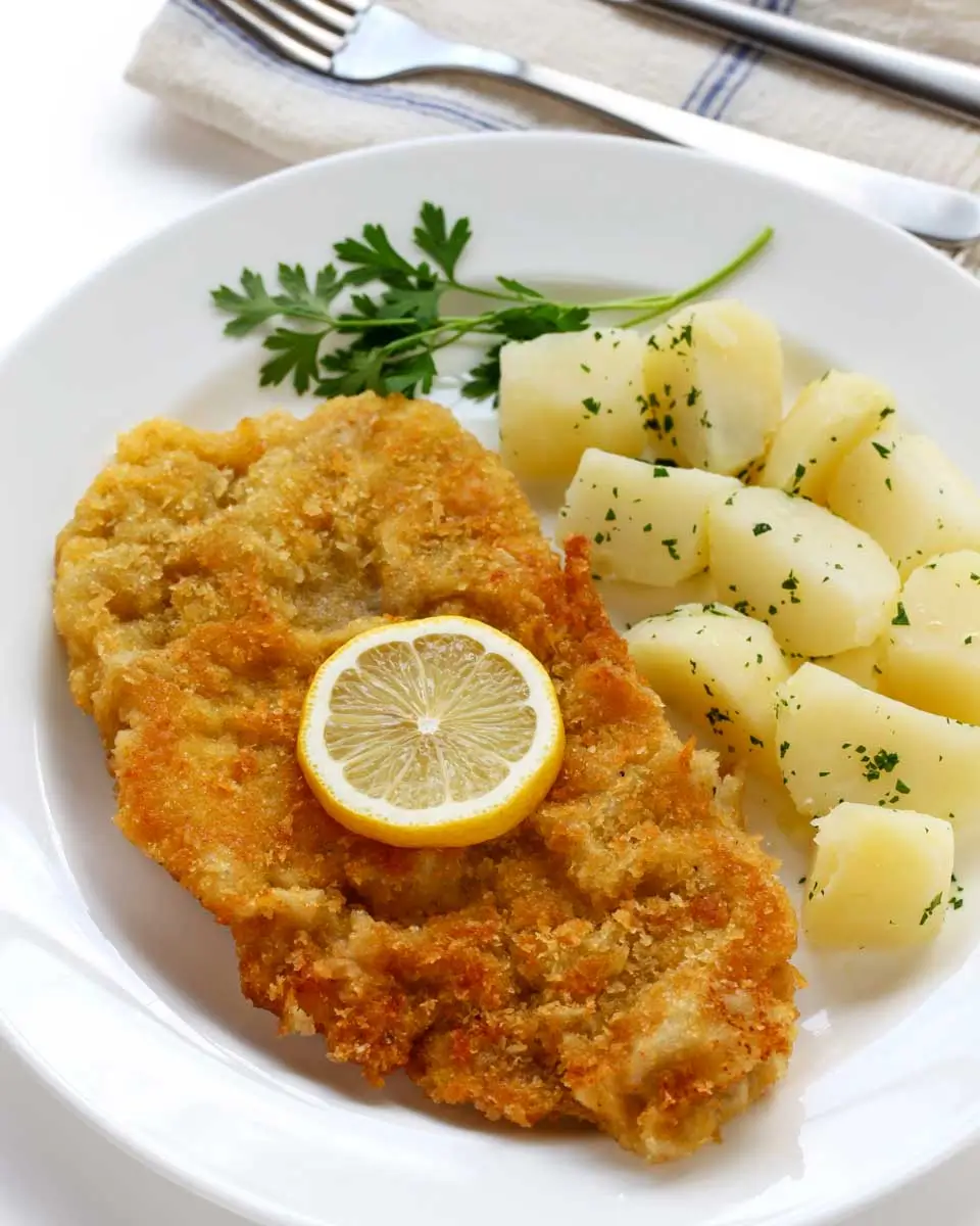 Freshly prepared Wiener Schnitzel served during a cooking class in Vienna