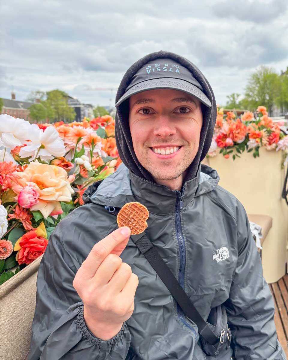 Jesse eats a stroopwafle on a food tour in Amsterdam