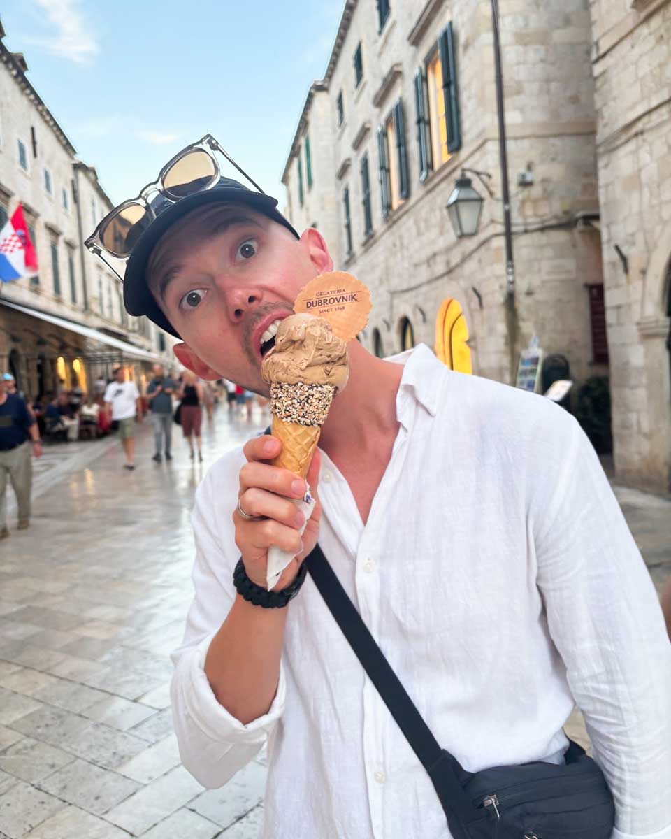 Jesse licks his ice cream cone from Gelateria Dubrvonik_