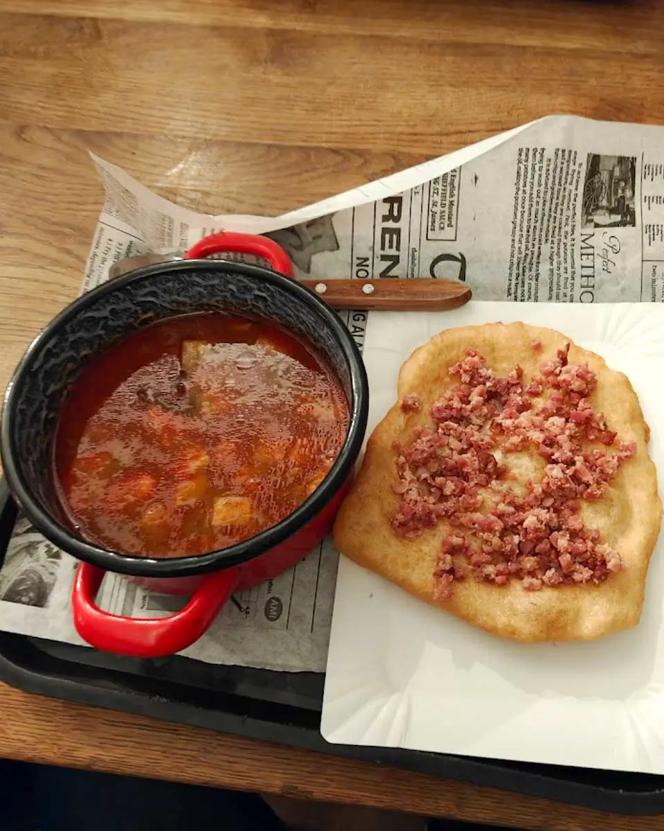 Traditional Hungarian goulash served with freshly made lángos during a food tour in Budapest