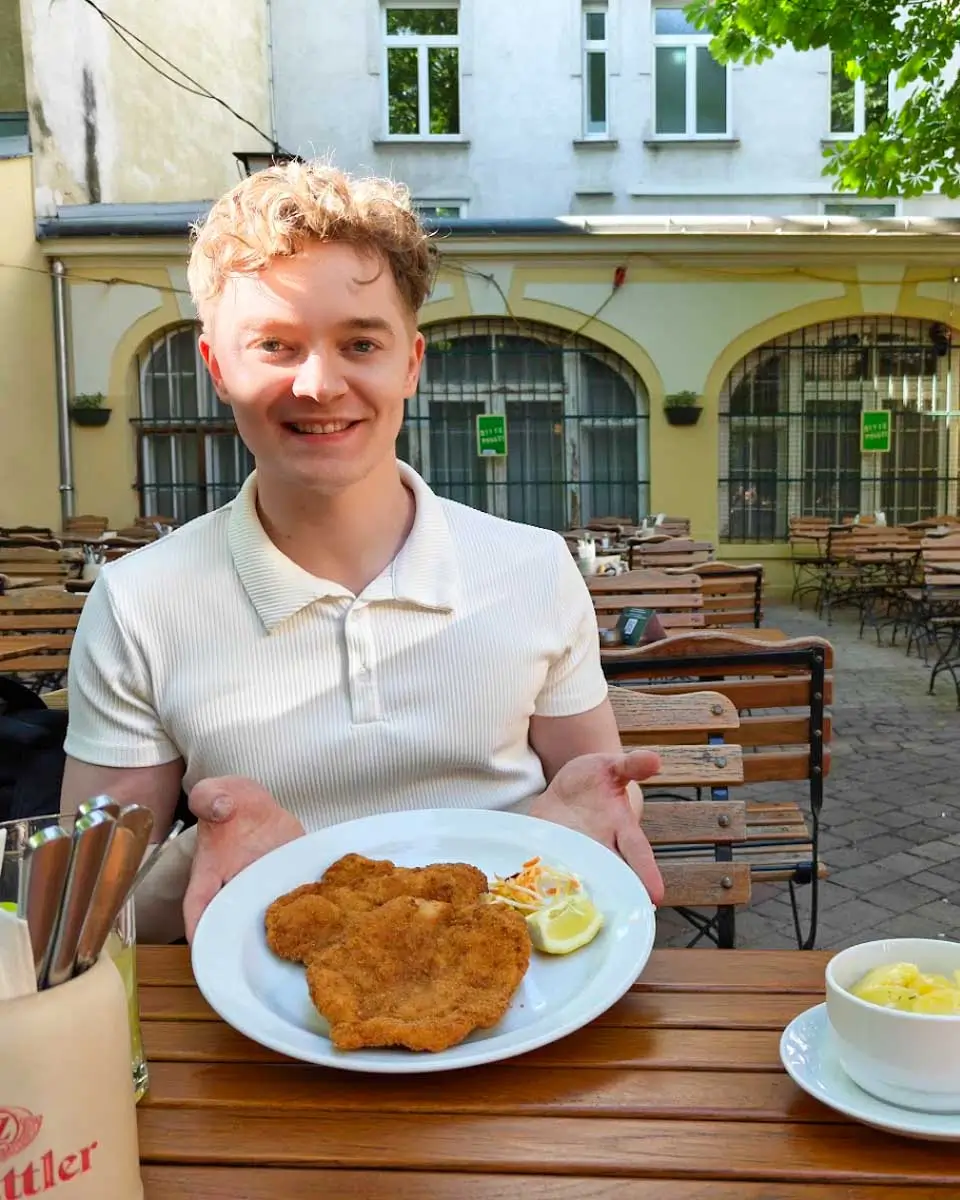 Luke enjoying Wiener schnitzel at Brandauer Schlossbräu in Vienna