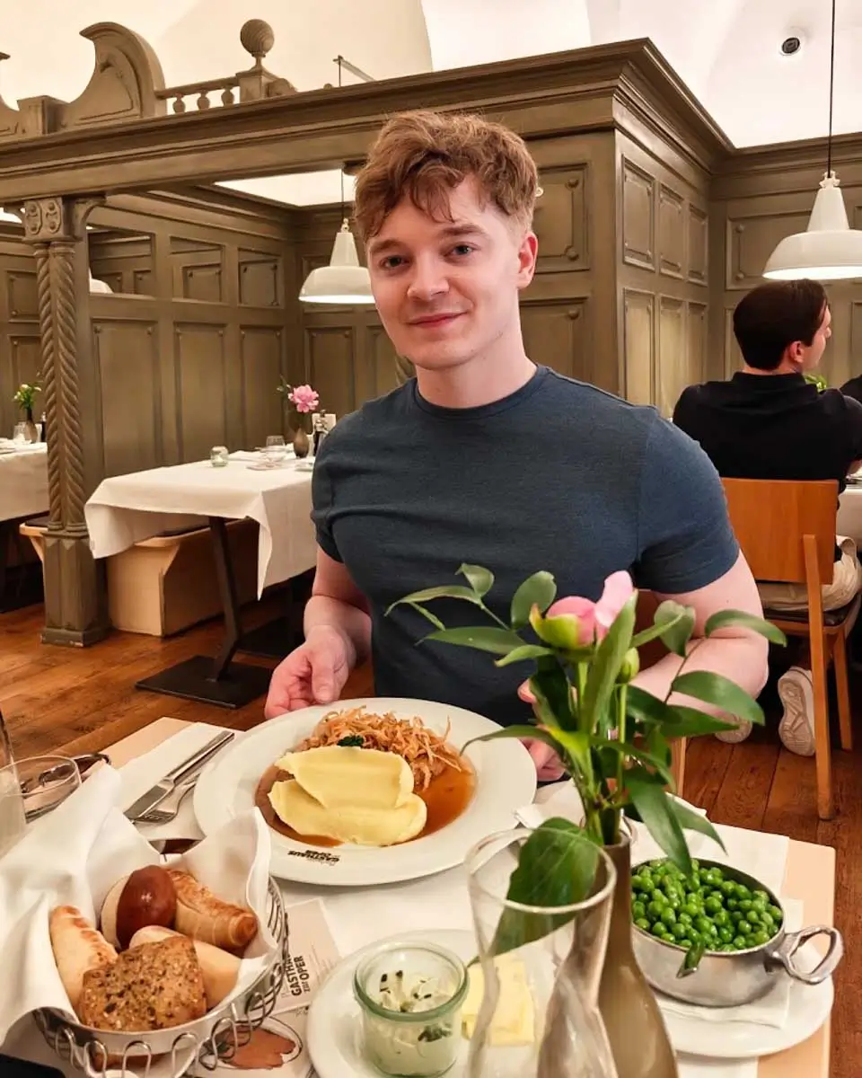 Luke having veal escalope at Plachutta Gasthaus zur Oper in Vienna