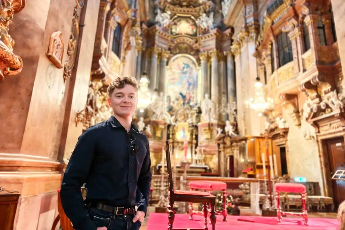 Luke standing inside St. Peter's Church in Vienna