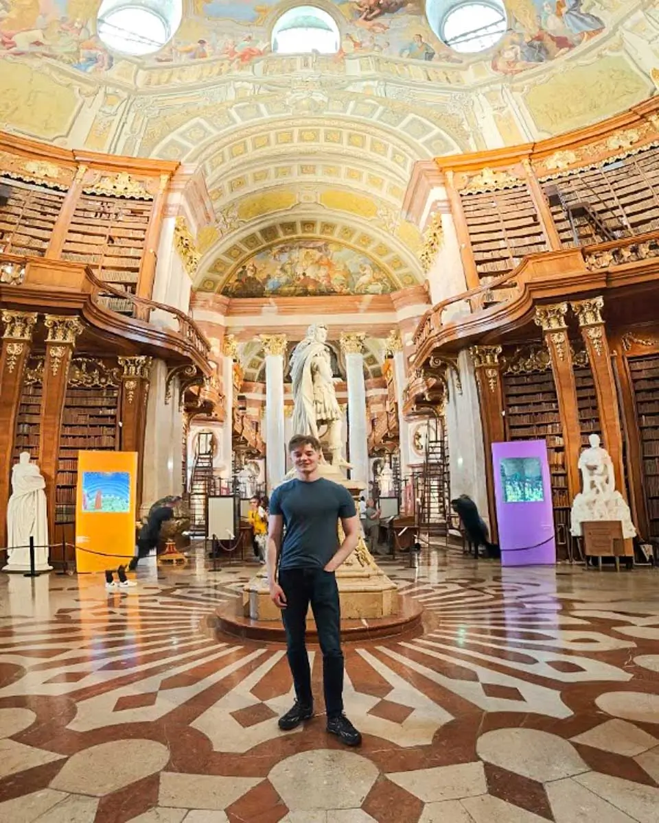 Luke standing inside the Austrian National Library in Vienna