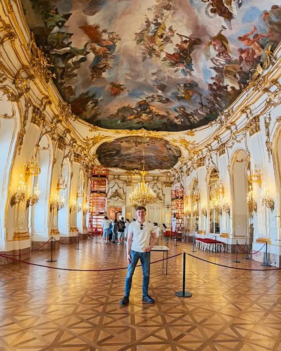 Luke standing inside Schönbrunn Palace in Vienna