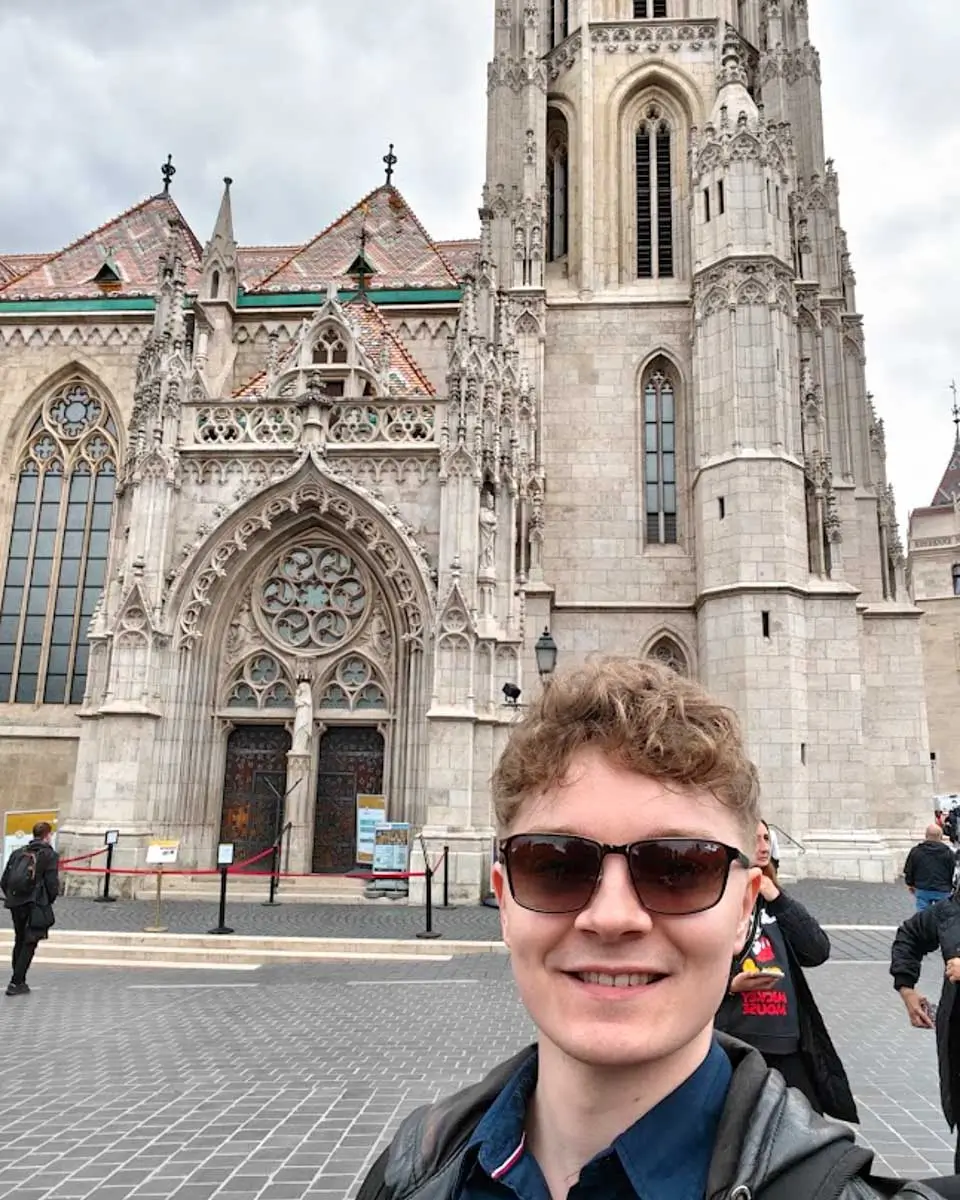 Luke taking selfie outside Matthias Church in Budapest