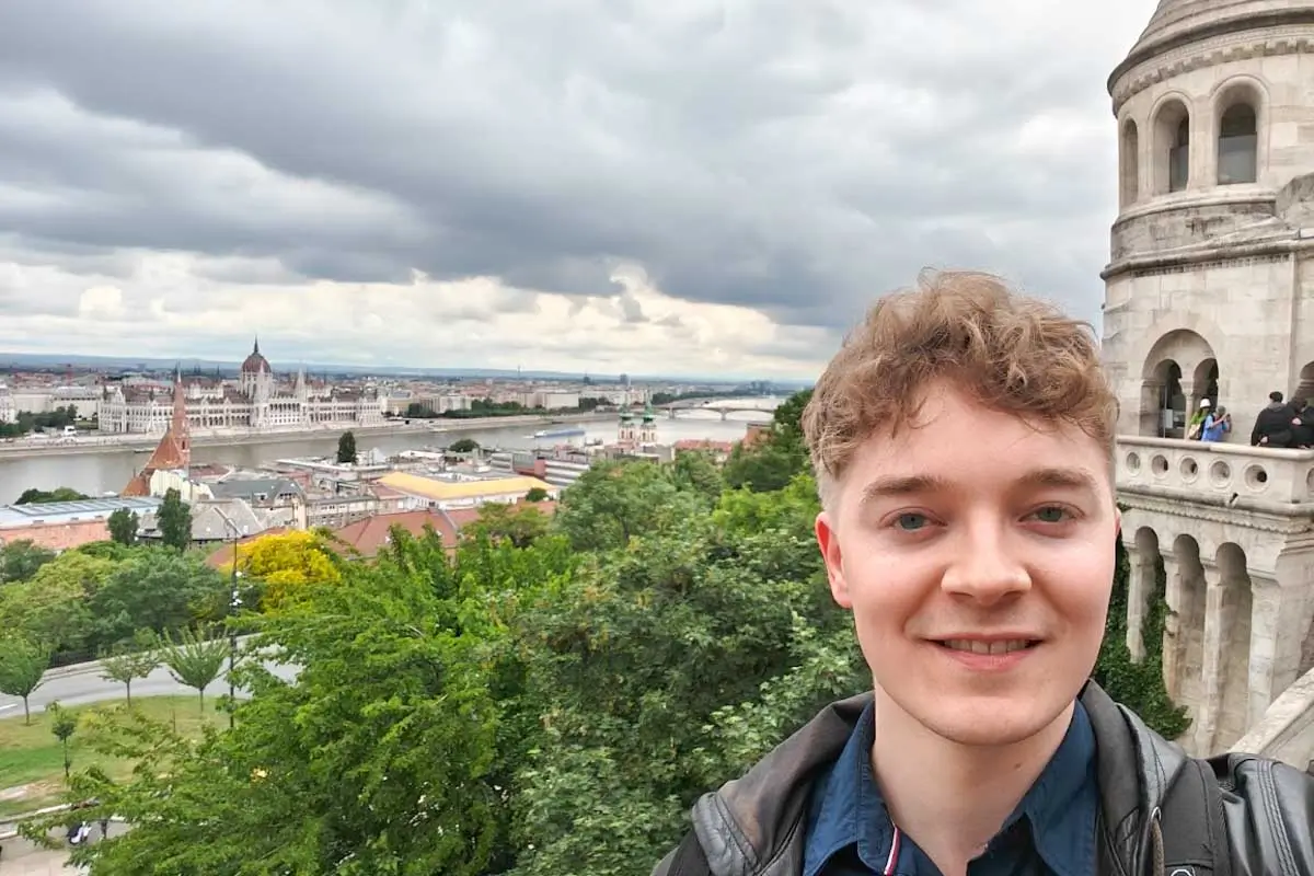 Luke taking a selfie from the Fisherman's Bastion viewpoint overlooking the Budapest skyline and the Danube River
