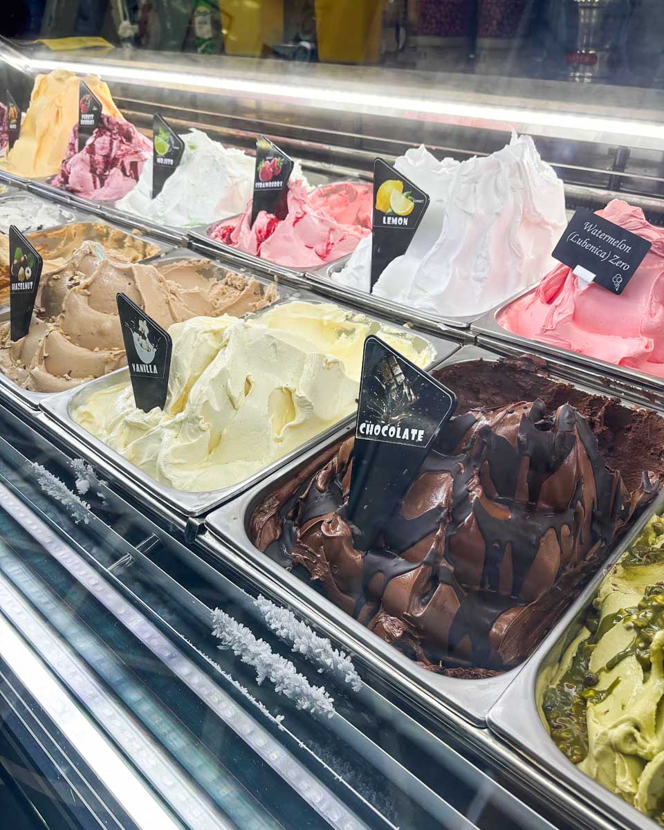 Multiple ice cream flavors behind the glass at Gelateria Dubrovnik